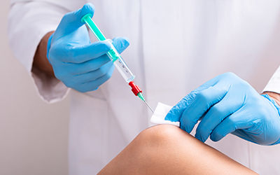 Doctor Makes Rejuvenation Beauty Injection On Woman's Knee