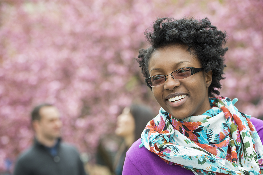 Smiling woman outdoors in springtime, representing renewed movement and joint health after regenerative cartilage therapy.